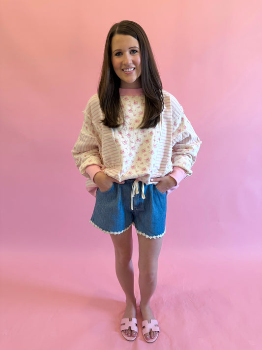 Pink floral sweatshirt with shabby chic aesthetic, perfect for spring and summer styling with shorts or jeans.
