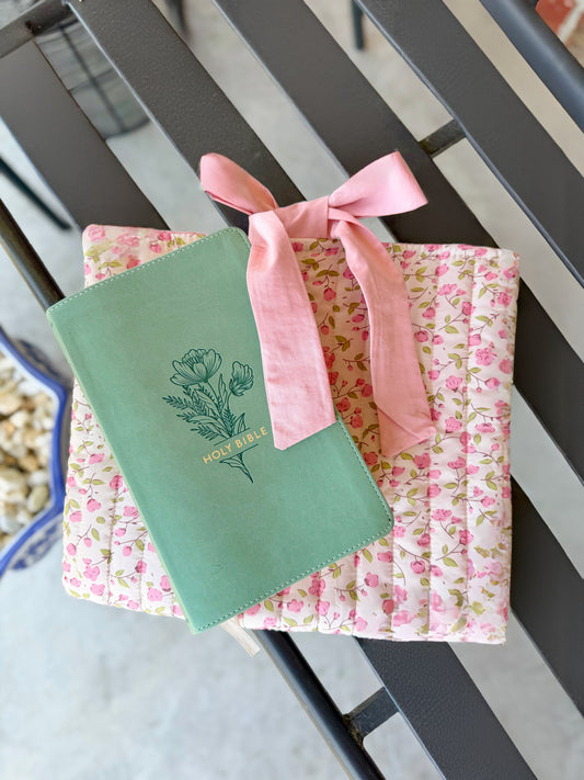 Pink quilted floral Bible cover with bow tie closure — a beautiful and practical accessory for your Bible or a thoughtful gift