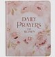 Pink floral hardcover book titled Daily Prayers for Women, featuring soft pastel flower designs