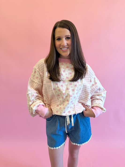 Pink floral sweatshirt with shabby chic aesthetic, perfect for spring and summer styling with shorts or jeans.