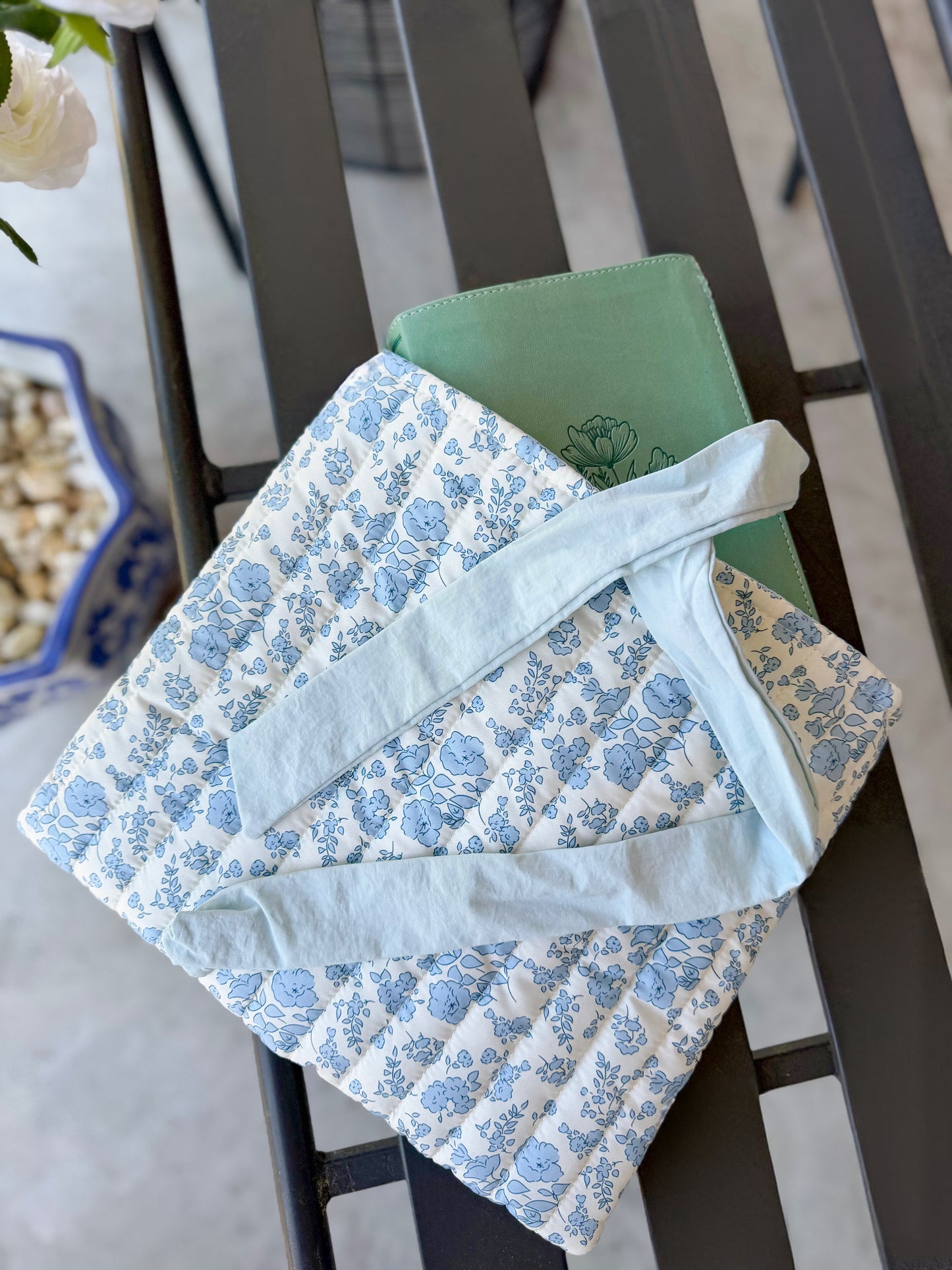 Blue quilted floral Bible cover with bow tie closure — a beautiful and practical accessory for your Bible or a thoughtful gift