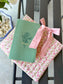 Pink quilted floral Bible cover with bow tie closure — a beautiful and practical accessory for your Bible or a thoughtful gift