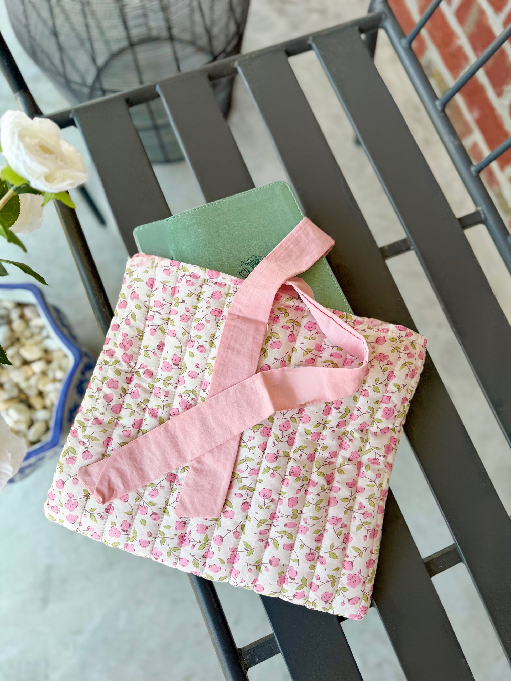 Pink quilted floral Bible cover with bow tie closure — a beautiful and practical accessory for your Bible or a thoughtful gift