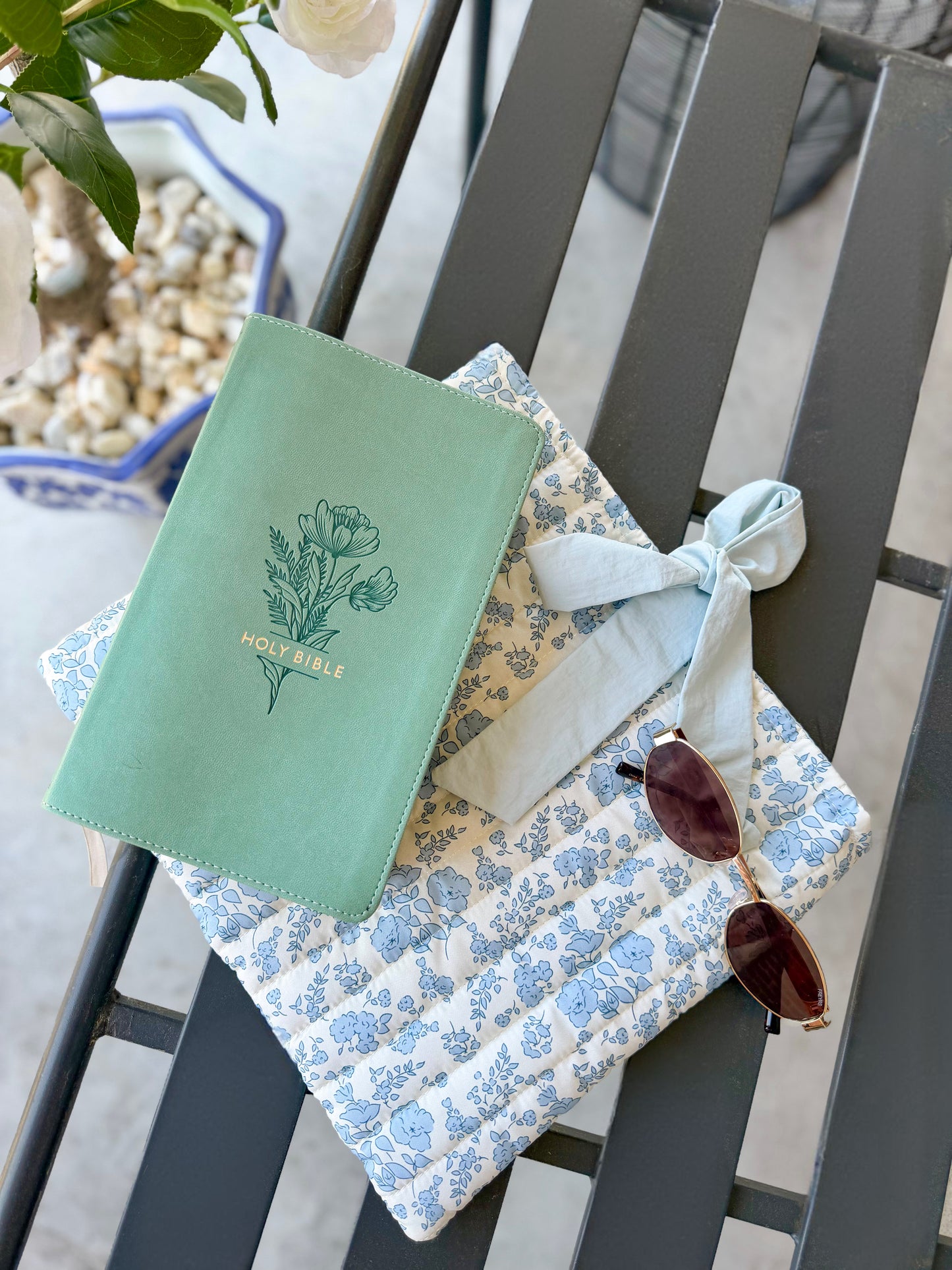 Blue quilted floral Bible cover with bow tie closure — a beautiful and practical accessory for your Bible or a thoughtful gift.